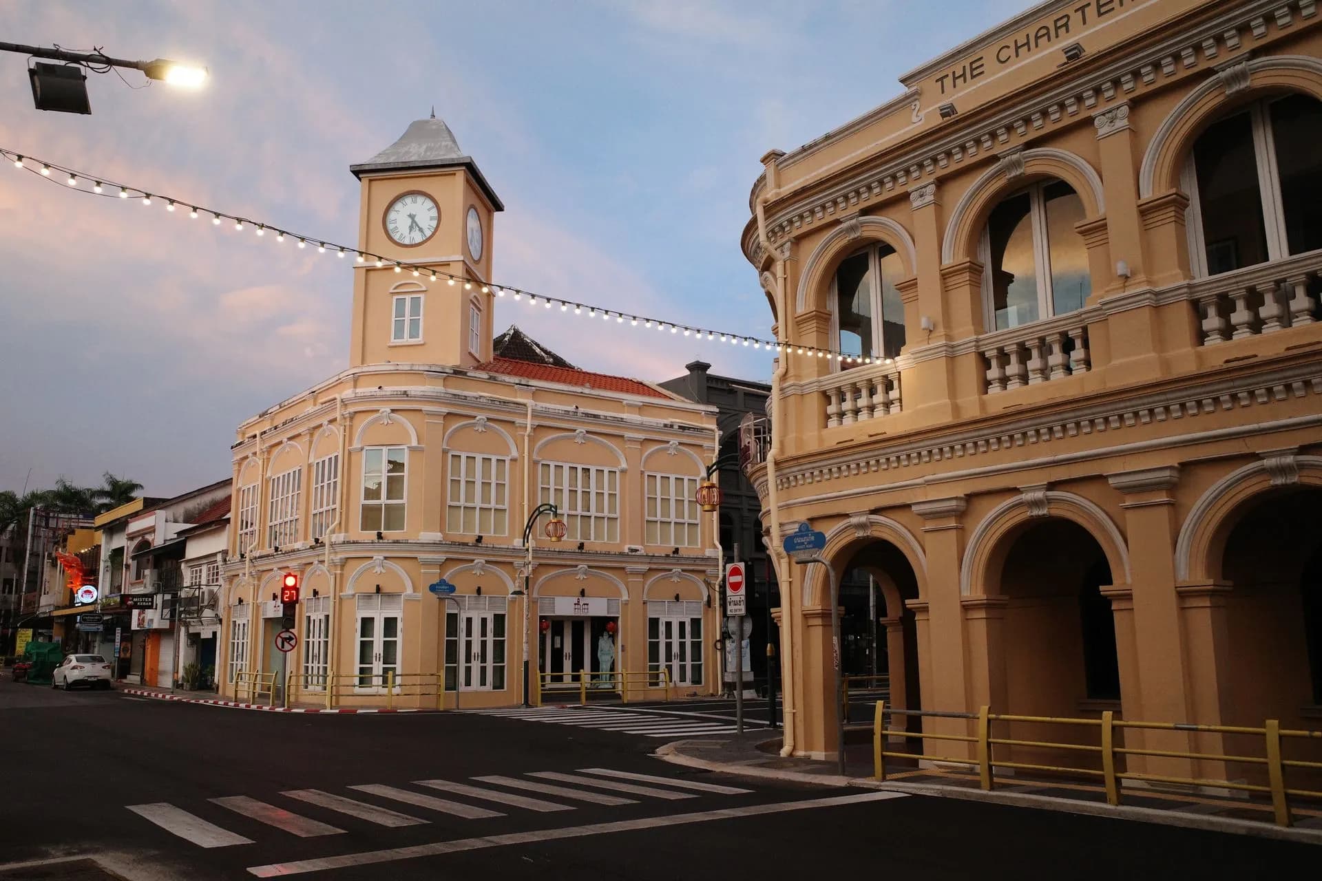 Pastel Sino-Portuguese shophouses with shuttered windows along a quiet street in Phuket Old Town